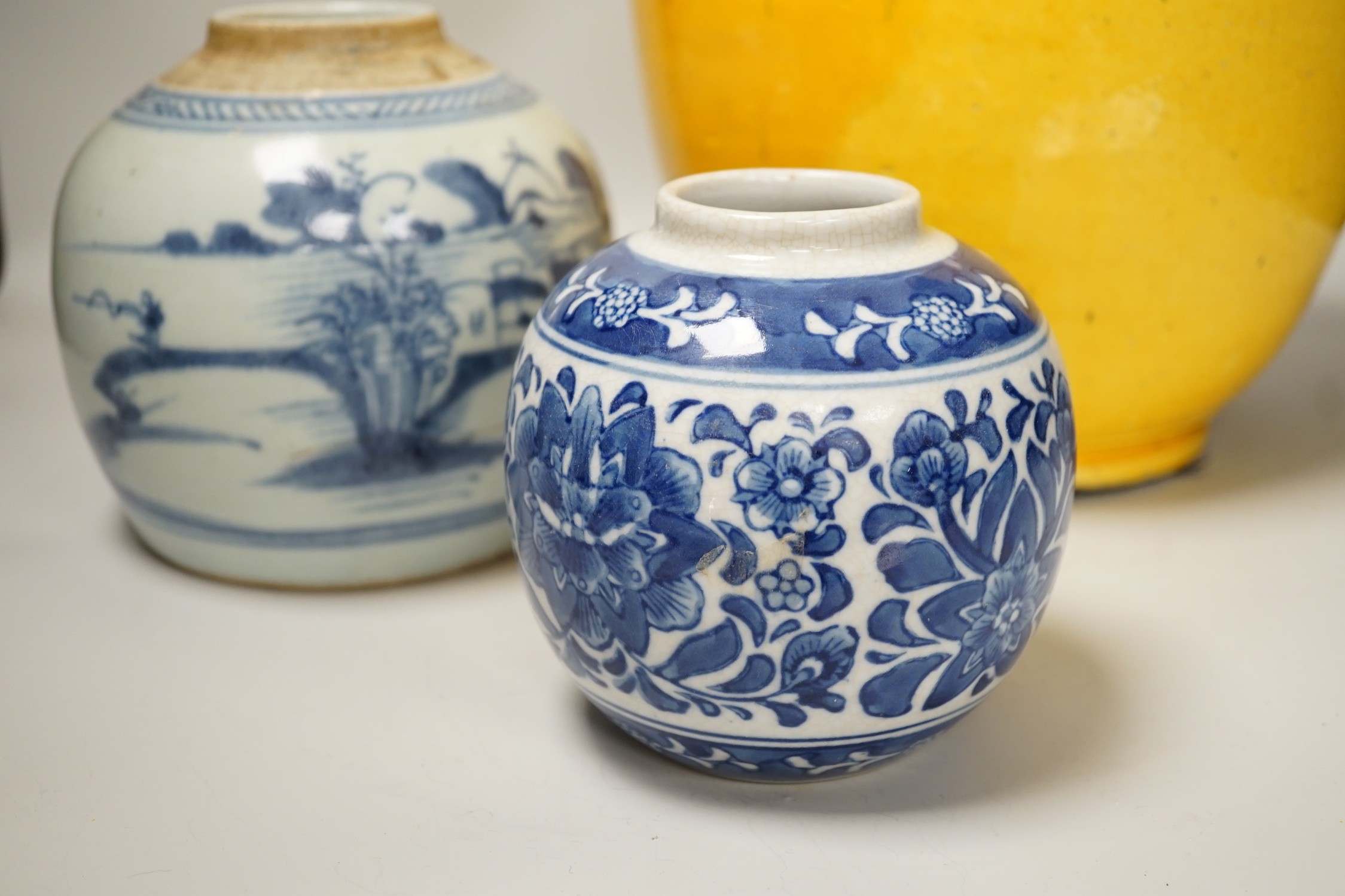 Two Chinese blue and white ginger jars, together with a large Chinese yellow glazed vase, tallest 31cm